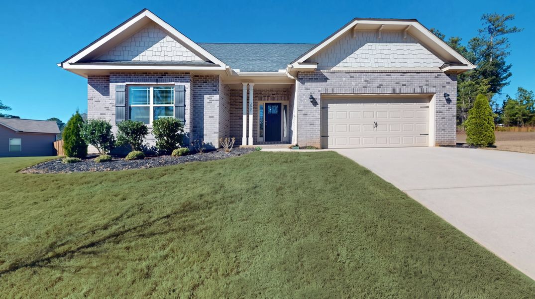 Front exterior of a new home in Holliday Pass, Griffin, GA, highlighting curb appeal (Image 1). Front exterior of a new home in Holliday Pass, Griffin, GA, highlighting curb appeal (Image 1).