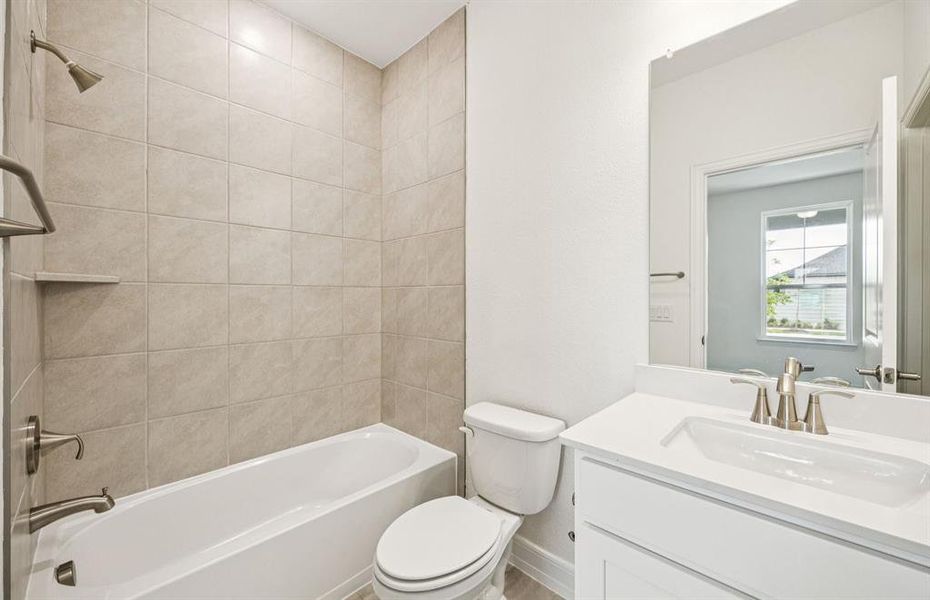 Secondary bathroom featuring modern upgrades and finishes *Real home pictured