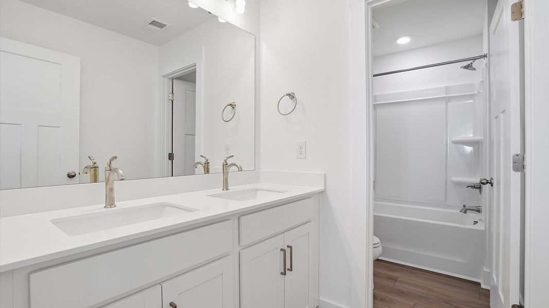 Superior bath with clean lines, contemporary lighting, and timeless style