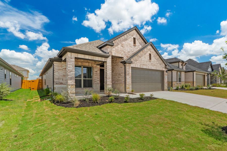 Front exterior of a new home in Prairie Winds, Hutto, TX, highlighting curb appeal (Image 22). Front exterior of a new home in Prairie Winds, Hutto, TX, highlighting curb appeal (Image 22).