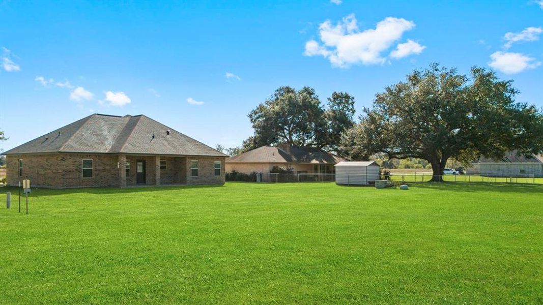 View from the back of the property line. Kids and pets can run and play. Ample room for a pool, garden, possibilities are endless given the size of your backyard.