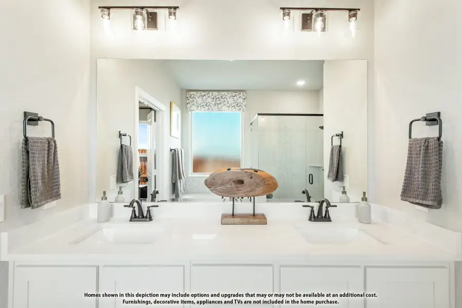 Bathroom with double sink vanity, white countertops, large mirror, and glass shower in background Bathroom with double sink vanity, white countertops, large mirror, and glass shower in background