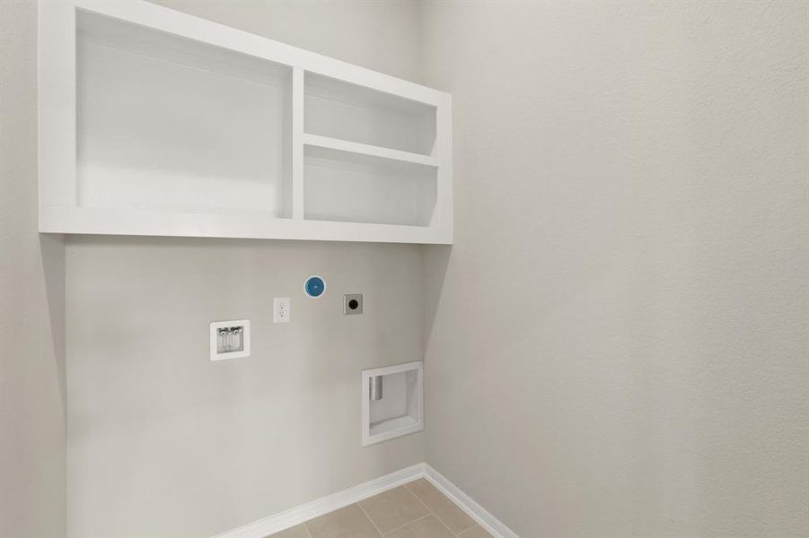 The laundry room layout is carefully planned for optimal workflow with designated areas for washing, drying, and storing.