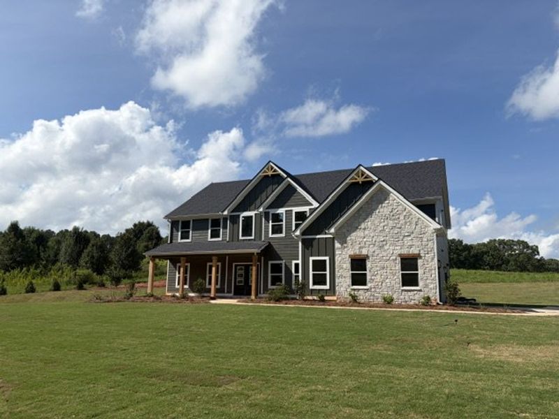 Front exterior of a new home in Blackwelder Bluff, Bowdon, GA, highlighting curb appeal (Image 2). Front exterior of a new home in Blackwelder Bluff, Bowdon, GA, highlighting curb appeal (Image 2).