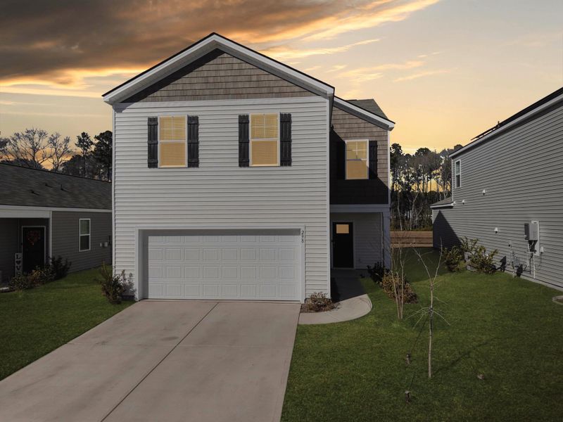 Front exterior of a new home in Pine Hills at Cane Bay, Summerville, SC, highlighting curb appeal (Image 2). Front exterior of a new home in Pine Hills at Cane Bay, Summerville, SC, highlighting curb appeal (Image 2).