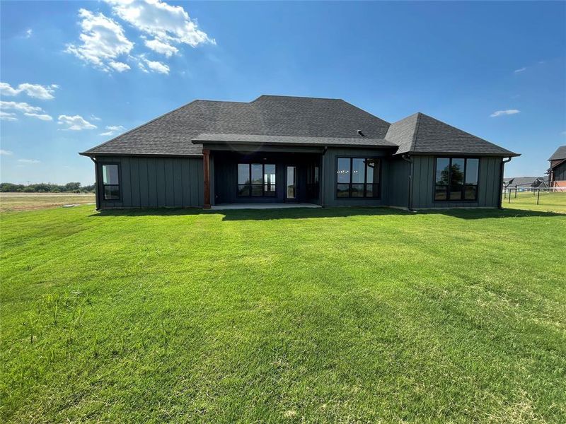 Rear view of house featuring a yard