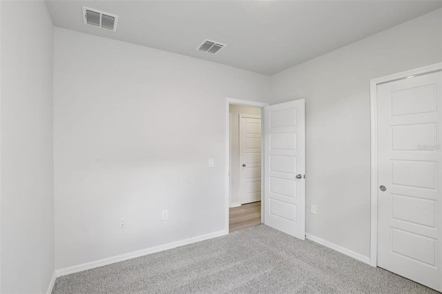 Spacious, unfurnished interior of a new home in Crescent Lakes - Premier Series, Punta Gorda (Image 27).