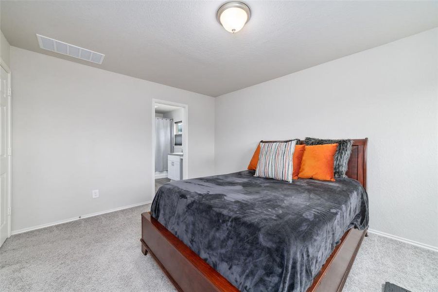 The two additional bedrooms are generously sized, featuring plush carpet and plenty of closet space. These rooms are perfect for family, guests, or can be easily transformed into a home office or playroom.