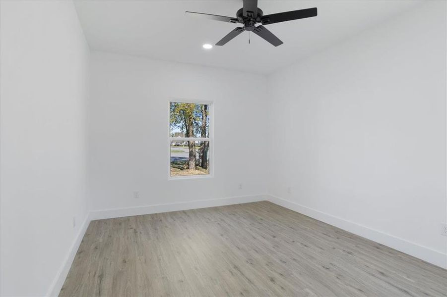 Spare room with ceiling fan and light hardwood / wood-style flooring