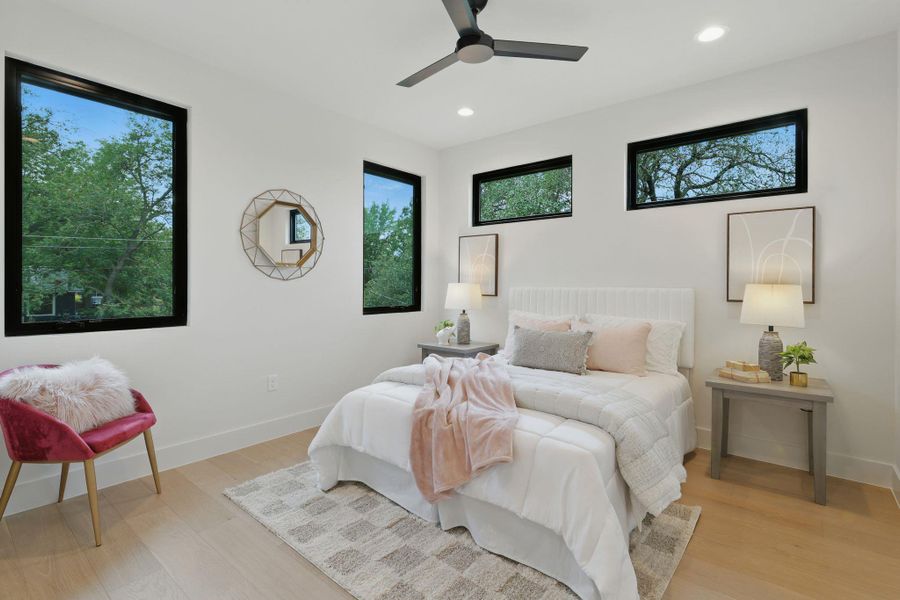 Bedroom with multiple windows, light wood-type flooring, recessed lighting, and a ceiling fan