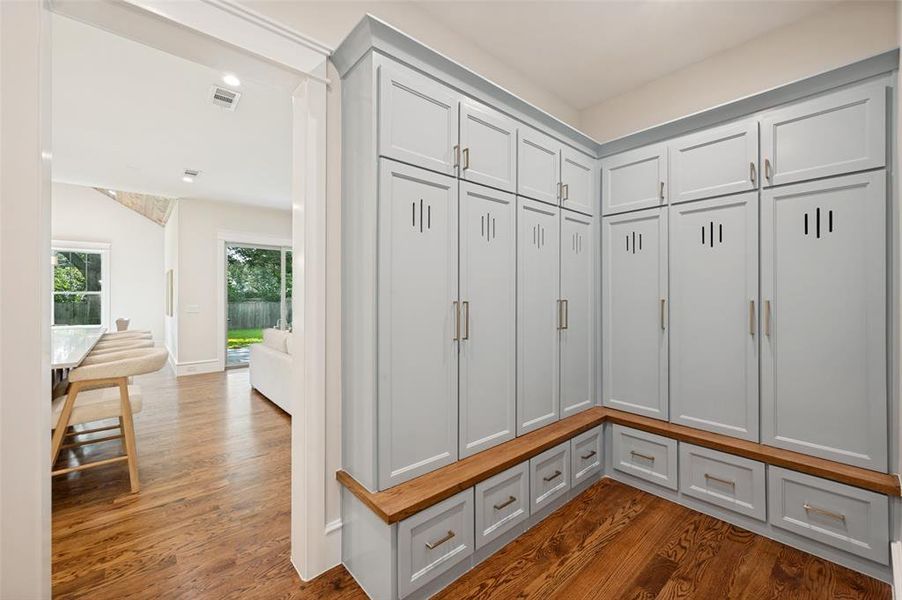 Built-in cabinetry featuring light blue panel doors, slotted vents, and brushed nickel hardware