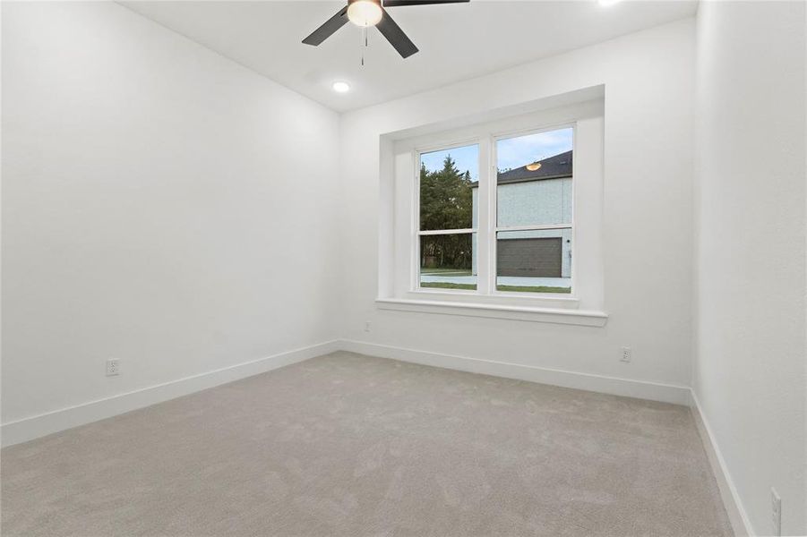 Carpeted spare room with a ceiling fan and recessed lighting Carpeted spare room with a ceiling fan and recessed lighting