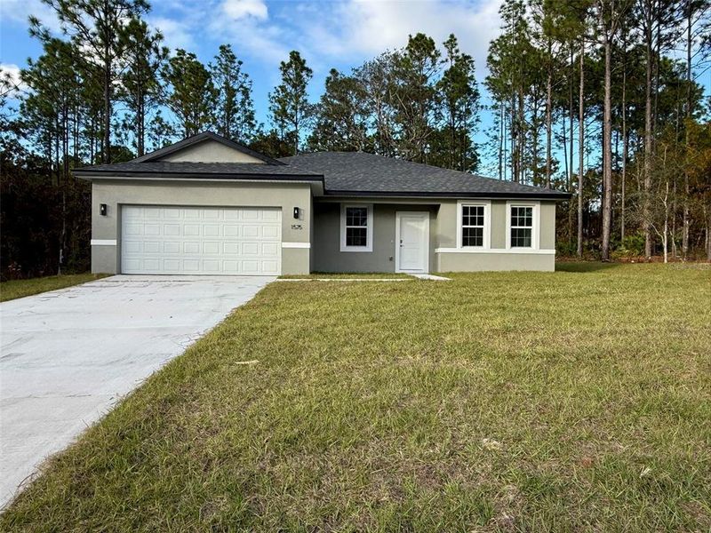 Front exterior of a new home in , Citrus Springs, FL, highlighting curb appeal (Image 1).
