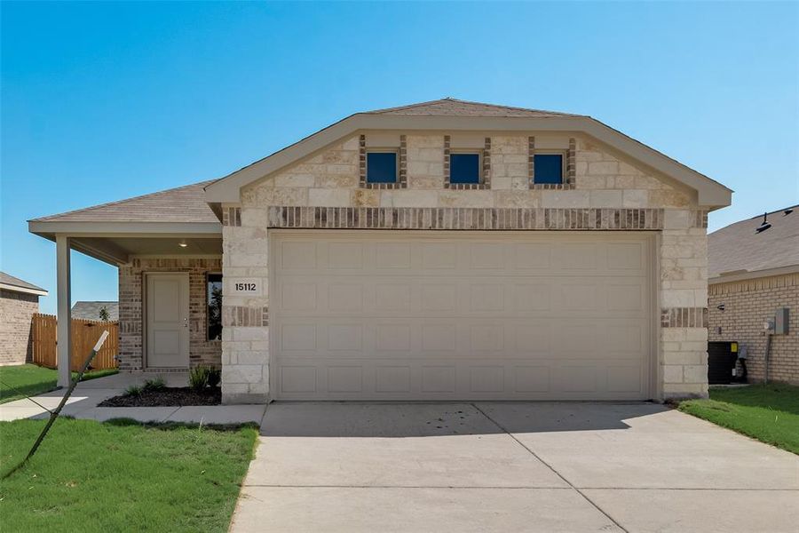 View of front of property featuring a garage and central AC unit