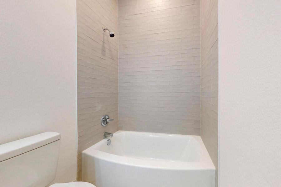 Full bathroom featuring toilet and shower / washtub combination