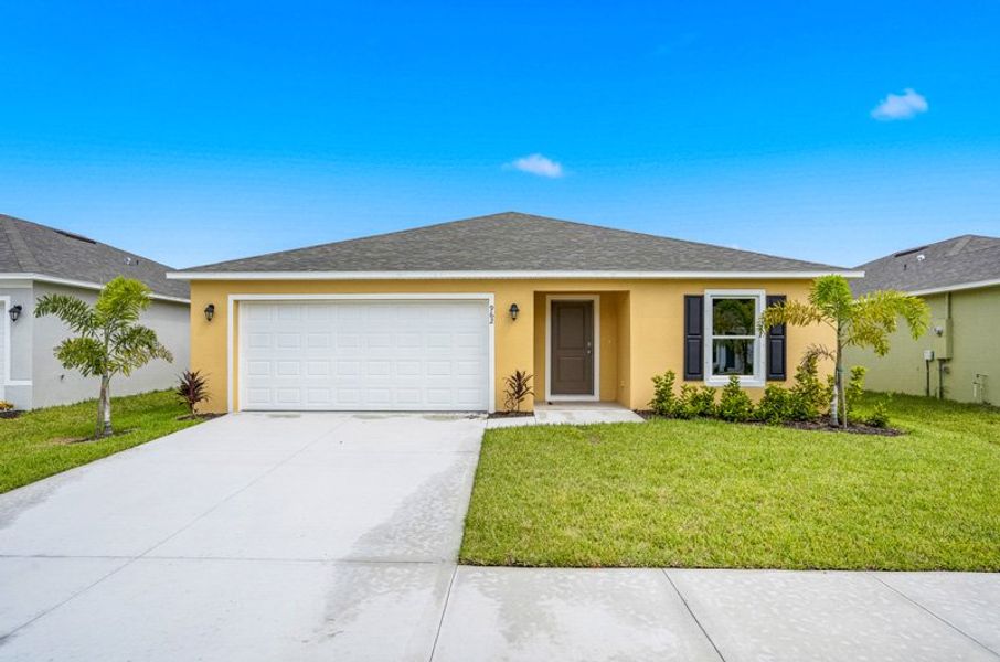 Front exterior of a new home in Richmond Cove, Palm Bay, FL, highlighting curb appeal (Image 2). Front exterior of a new home in Richmond Cove, Palm Bay, FL, highlighting curb appeal (Image 2).