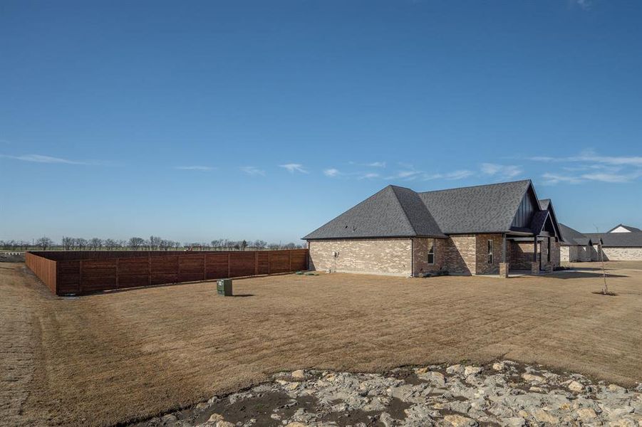 View of side of property featuring a lawn