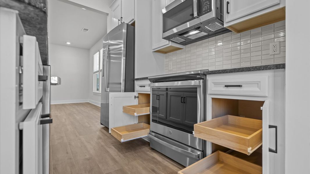 Tasteful design meets functional luxury in this kitchen with a 9-foot island and modern pendant lighting