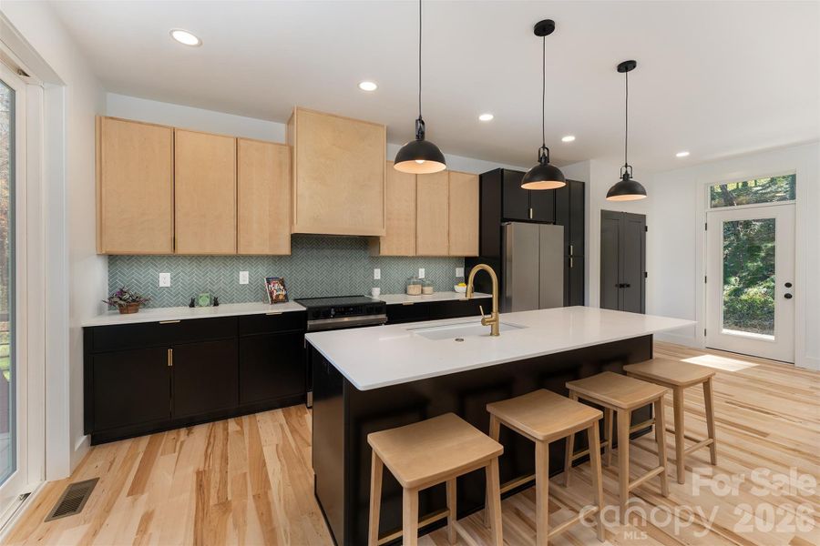 Beautiful kitchen with custom stove hood and roll-outs in the pantry and cupboards