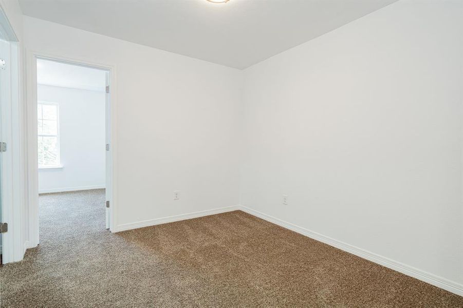 Spare room featuring carpet