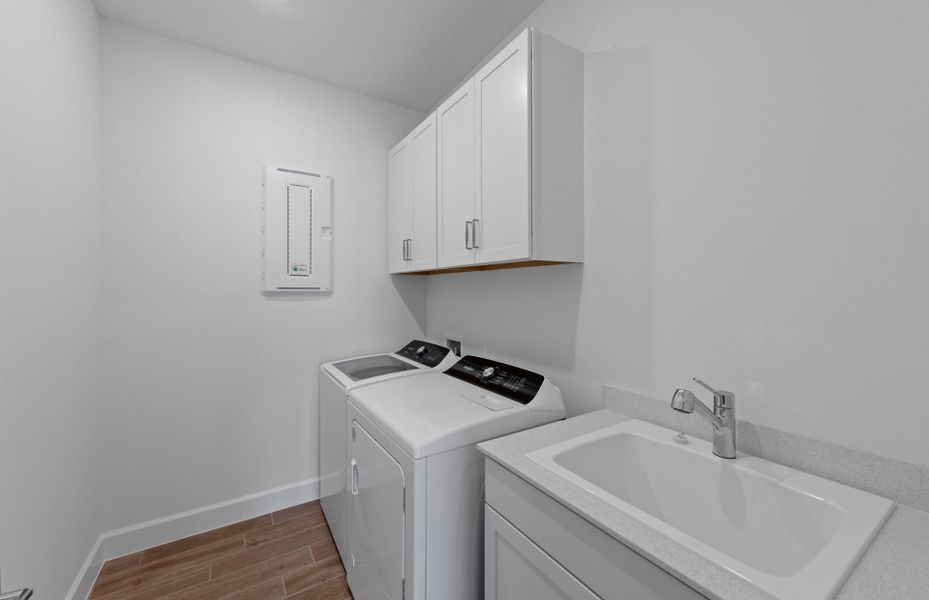 Spacious laundry room featuring a sink and additional storage space