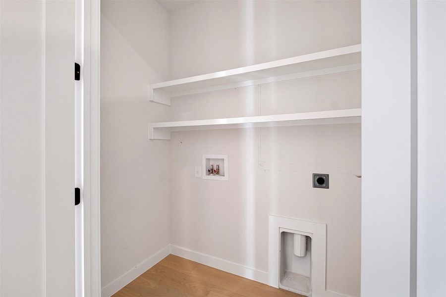 Laundry area with light wood-style floors, hookup for an electric dryer, and hookup for a washing machine