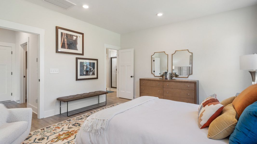 The Sutherland Design highlights a primary suite with a spacious layout and relaxing atmosphere