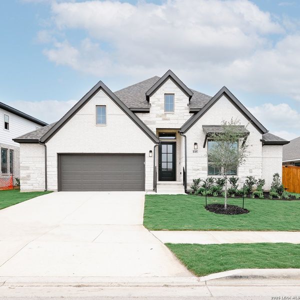 Front exterior of a new home in Veramendi, New Braunfels, TX, highlighting curb appeal (Image 22).