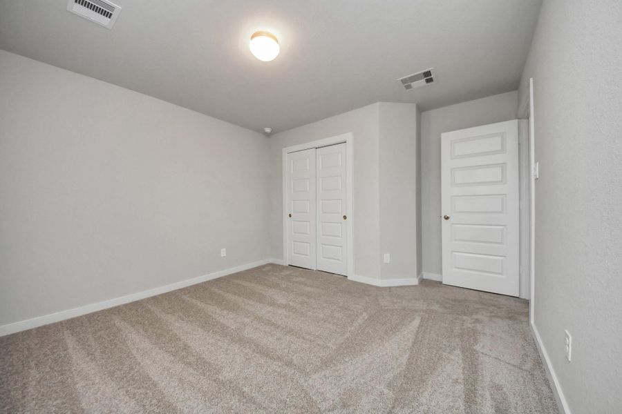 Generously sized secondary bedrooms featuring spacious closets, soft and inviting carpetingunderfoot, large windows allowing plenty of natural light, and the added touch of privacyblinds for your personal retreat. Sample photo of completed home with similar floor plan. Actual colors and selections may vary. Generously sized secondary bedrooms featuring spacious closets, soft and inviting carpetingunderfoot, large windows allowing plenty of natural light, and the added touch of privacyblinds for your personal retreat. Sample photo of completed home with similar floor plan. Actual colors and selections may vary.