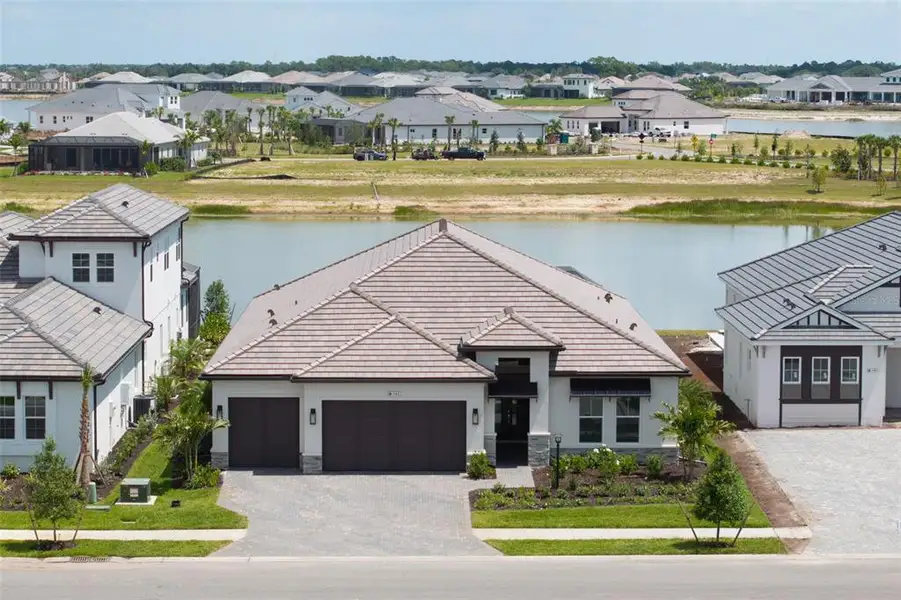 Front exterior of a new home in , Sarasota, FL, highlighting curb appeal (Image 27).