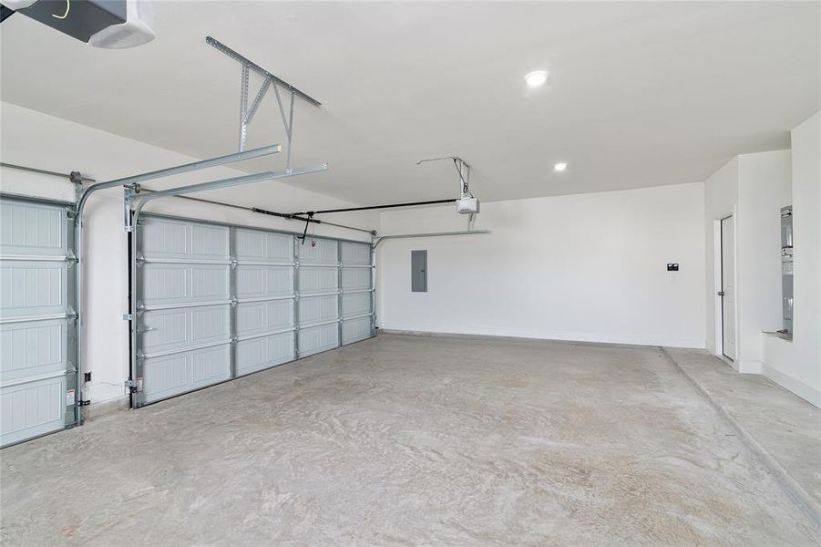 Garage with electric panel and a garage door opener