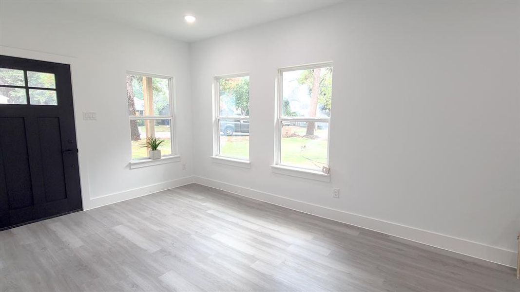 Entrance foyer with light hardwood / wood-style flooring and plenty of natural light