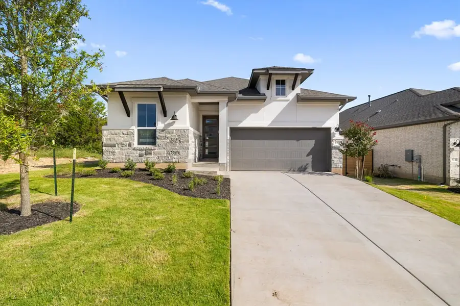 Front exterior of a new home in Arbor Collection At Wolf Ranch, Georgetown, TX, highlighting curb appeal (Image 1).