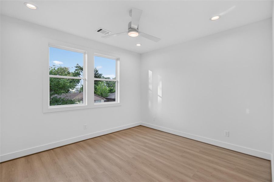 Located at the front of the home, this spacious secondary bedroom offers abundant natural light, generous closet space, and a quiet retreat. Located at the front of the home, this spacious secondary bedroom offers abundant natural light, generous closet space, and a quiet retreat.