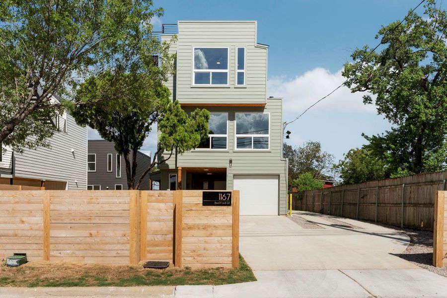 Modern home with concrete driveway and an attached garage