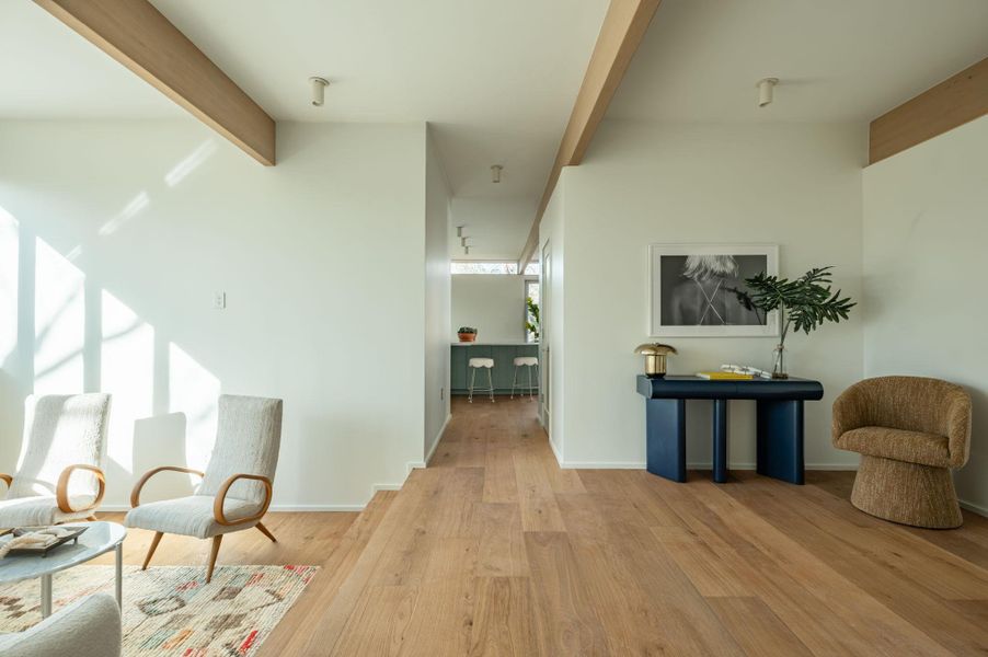Hallway featuring beamed ceiling and light wood-type flooring
