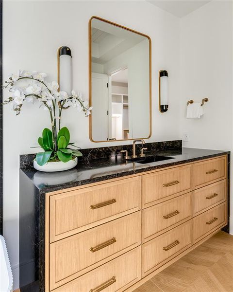 Bathroom with vanity and wood-type flooring