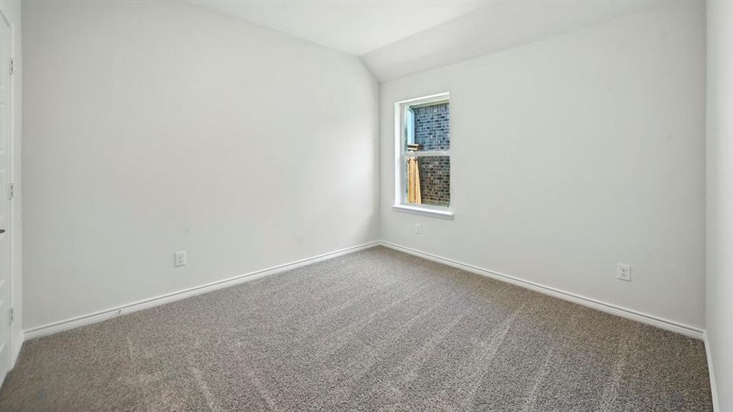 Neutral wall color with a single window and gray patterned carpeting Neutral wall color with a single window and gray patterned carpeting