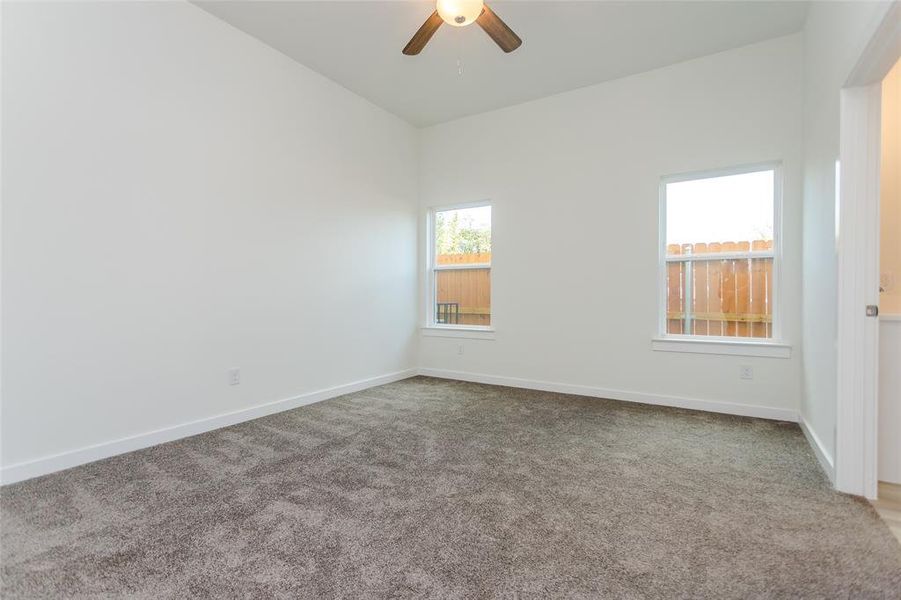 Spare room with lofted ceiling, carpet flooring, and ceiling fan