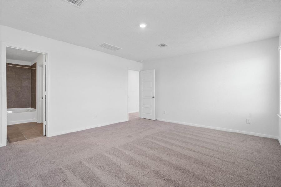 View of primary bedroom to the primary bathroom. View of primary bedroom to the primary bathroom.