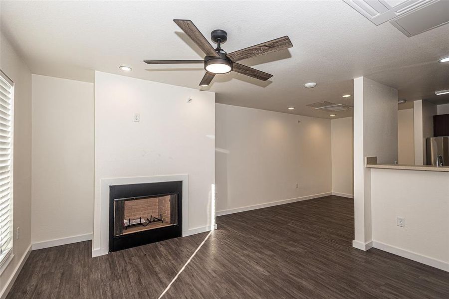 living room has wood burning fireplace and a healthy amount of sunlight