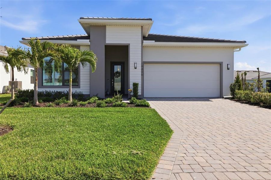 Front exterior of a new home in , Lakewood Ranch, FL, highlighting curb appeal (Image 1). Front exterior of a new home in , Lakewood Ranch, FL, highlighting curb appeal (Image 1).