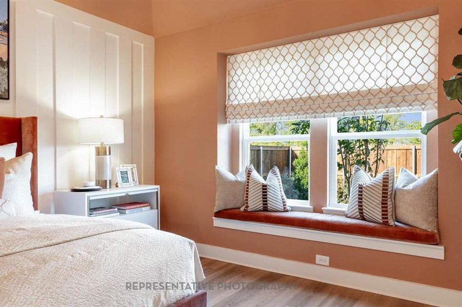 Bedroom with wood finished floors and baseboards