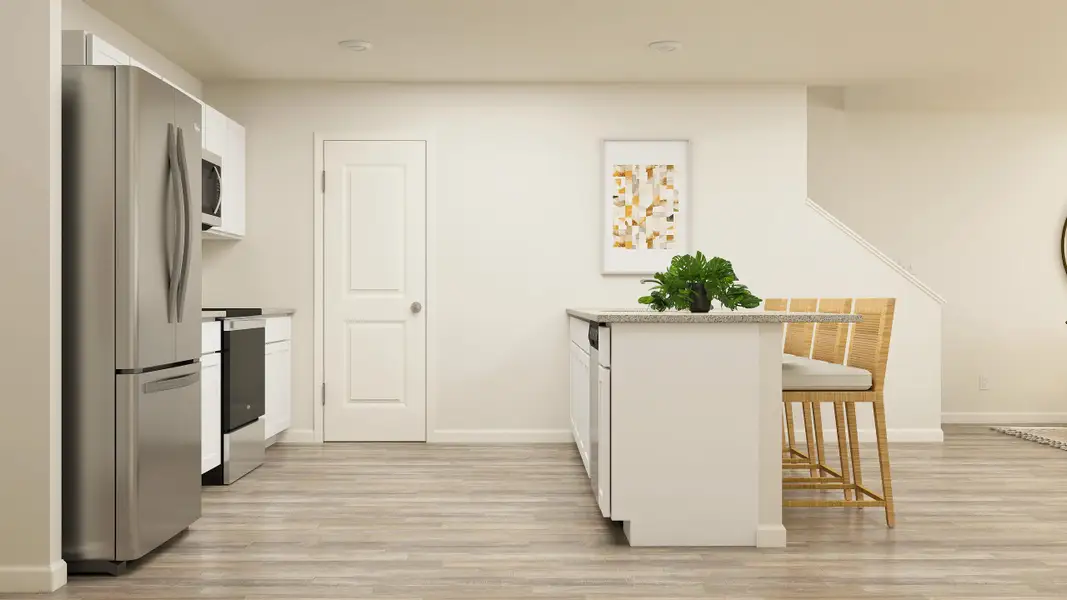 A kitchen with a table and chairs.