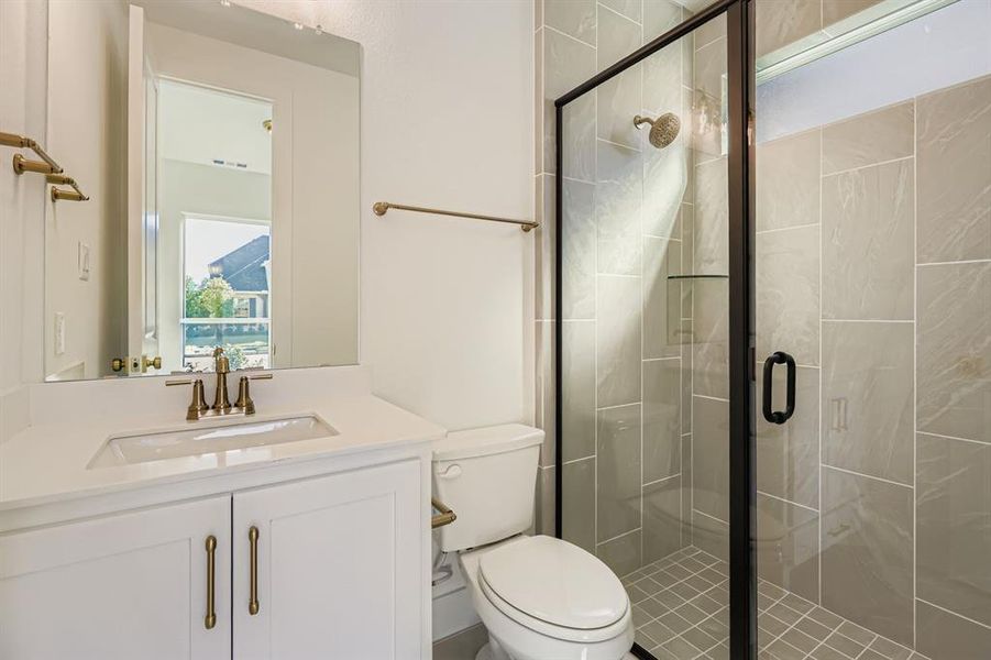 Bathroom featuring a stall shower and vanity Bathroom featuring a stall shower and vanity