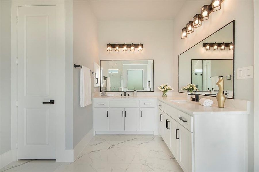 Bathroom with two vanities, light marble finish floors, and a shower stall Bathroom with two vanities, light marble finish floors, and a shower stall