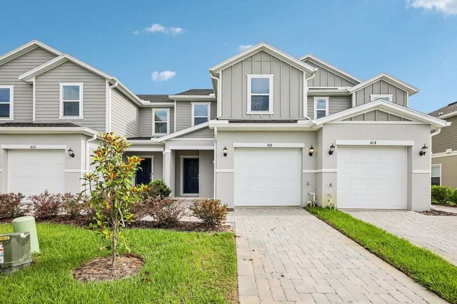 Front exterior of a new home in Reserve at Forest Lake Townhomes, Lake Wales, FL, highlighting curb appeal (Image 16). Front exterior of a new home in Reserve at Forest Lake Townhomes, Lake Wales, FL, highlighting curb appeal (Image 16).