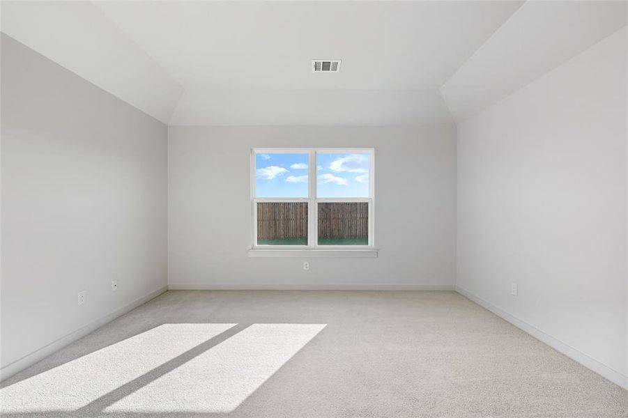 Spare room with light colored carpet and baseboards Spare room with light colored carpet and baseboards