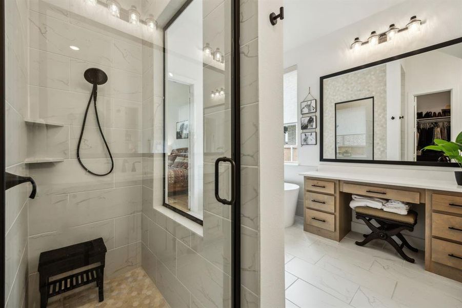 Full bathroom featuring tiled shower, vanity, marble look tile flooring, a soaking tub, and a spacious closet