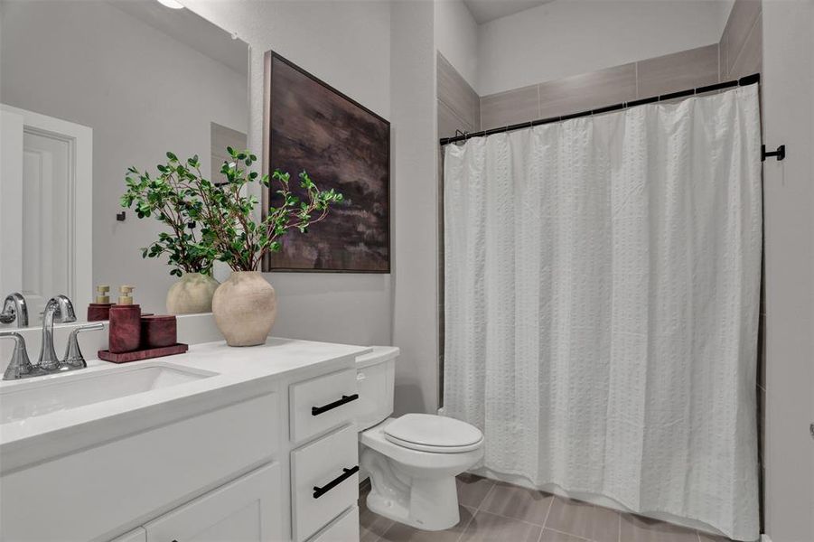 A beautifully appointed hall bath serves the secondary bedrooms, featuring warm finishes and a calm, contemporary palette. A beautifully appointed hall bath serves the secondary bedrooms, featuring warm finishes and a calm, contemporary palette.